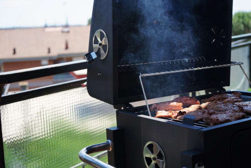 gas grill apartment balcony with meat