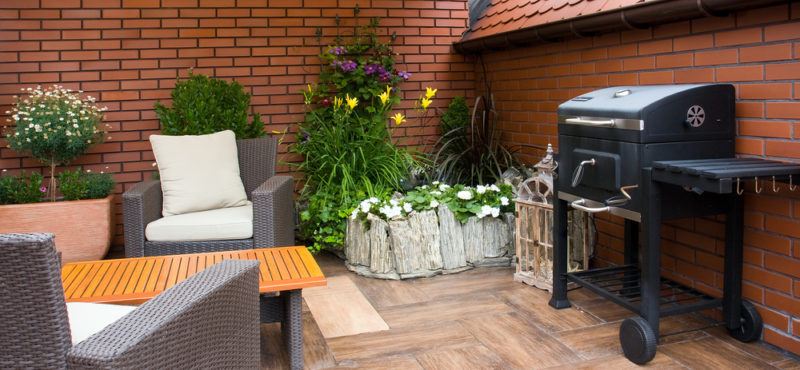 gas grill on brick apartment balcony