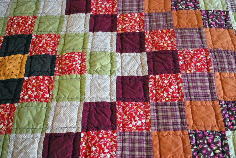 Handmade quilt with variety of colorful blocks and various design