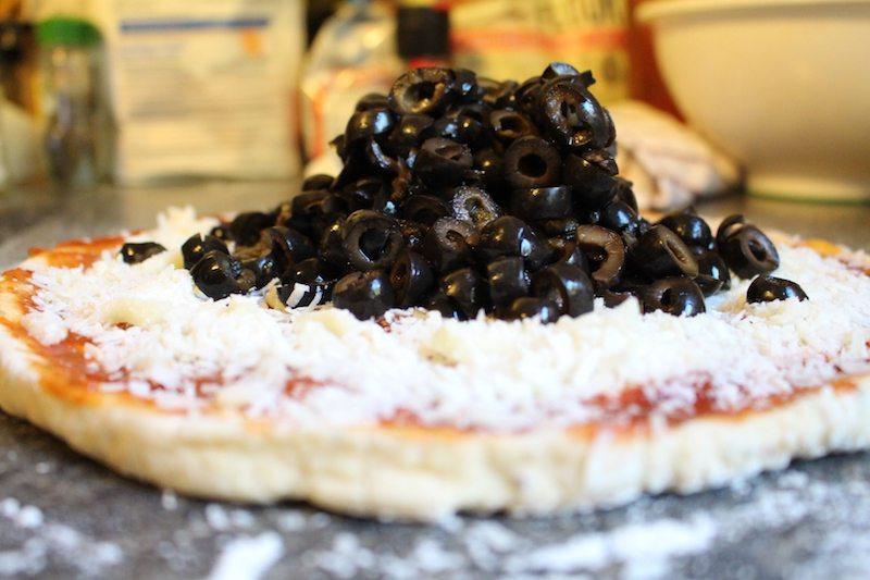 cheese pizza with huge pile of black olives on top