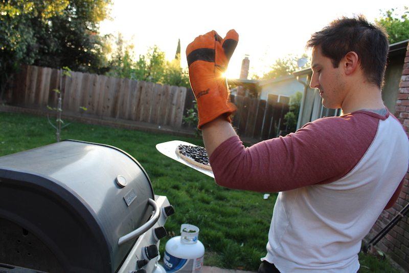 Roderick grilling outside, highlighting the idea of turning a grill into a makeshift pizza oven