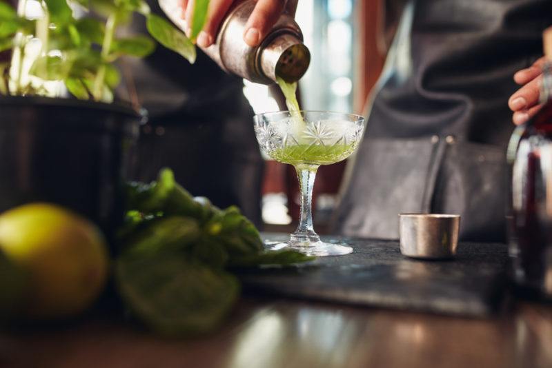 hop infused vodka cocktail being poured by old-timey bartender