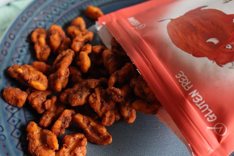 spicy walnuts spilled out of open package on a plate