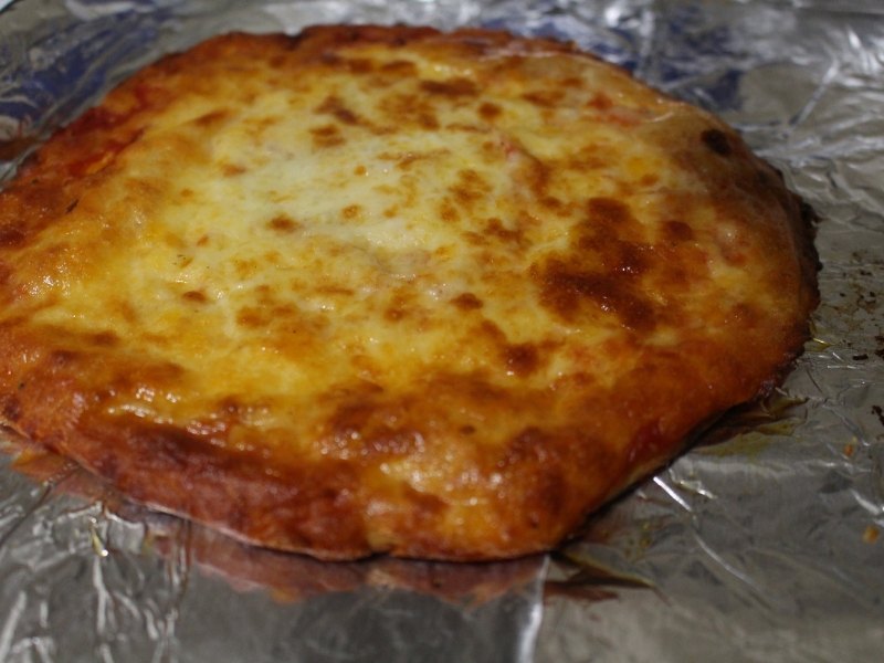 keto pizza fully cooked in the oven with melted cheese