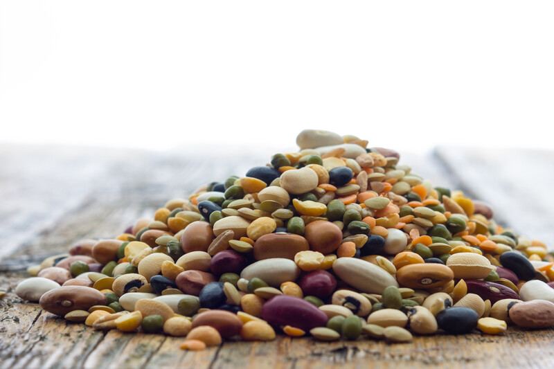 closeup image of a mound of legumes on a wooden surface