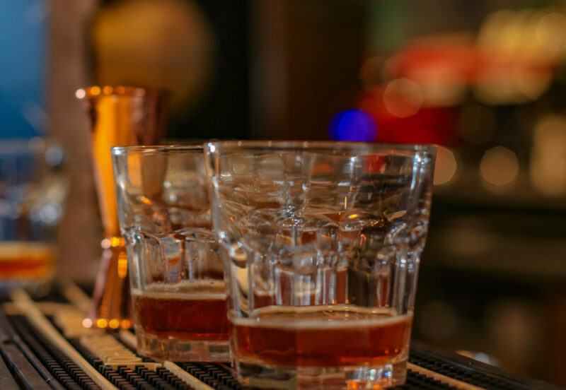 shot of liquid cocaine cocktail at a bar with copper jigger