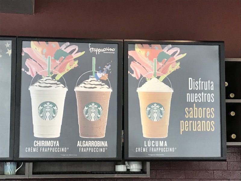 Signs at a Peru Starbucks, showing Frappuccinos made with lucuma and chirimoya