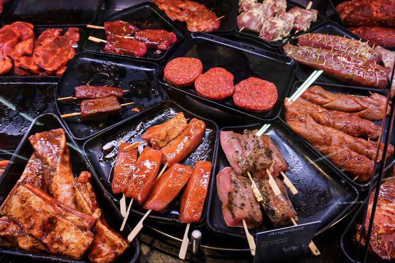 variety of meats on cast iron grill, showing what you can get in your meat of the month package