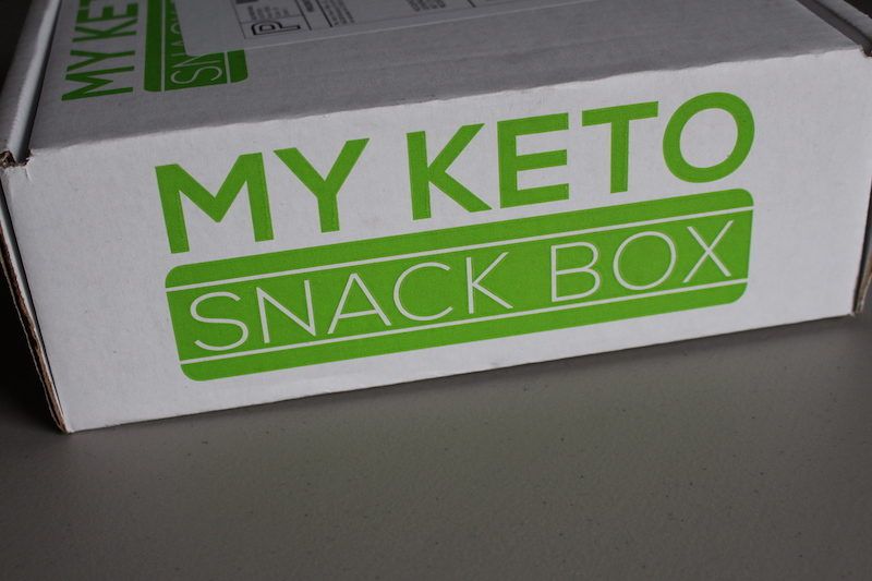 unopened white box with the green writing that says "My Keto Snack Box"