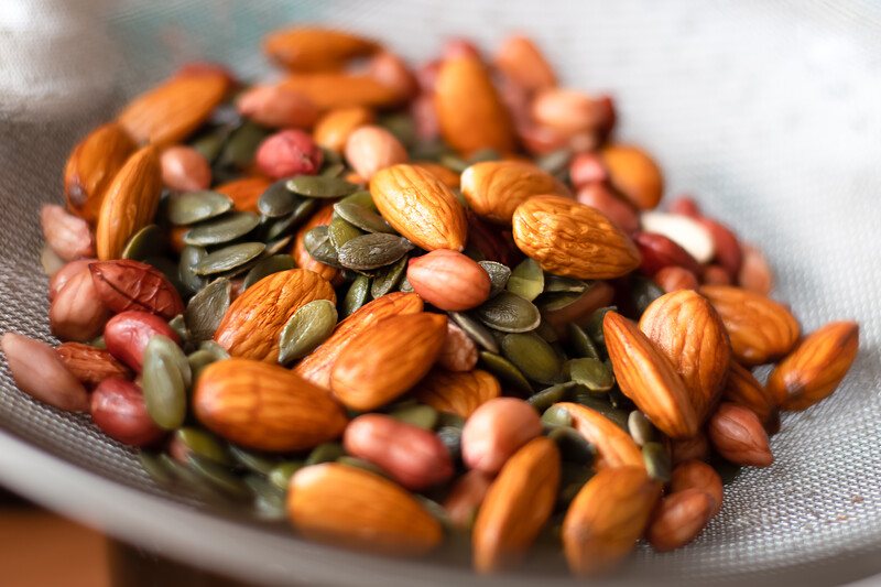 closeup image of a bowl full of different nuts and seeds