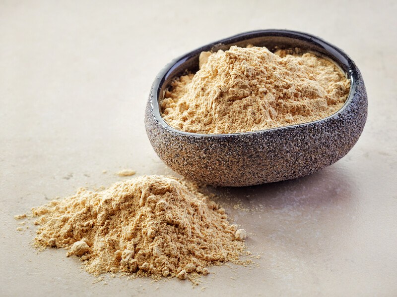 an odd-shaped bowl full of onion powder with a small heap of onion powder in front of it