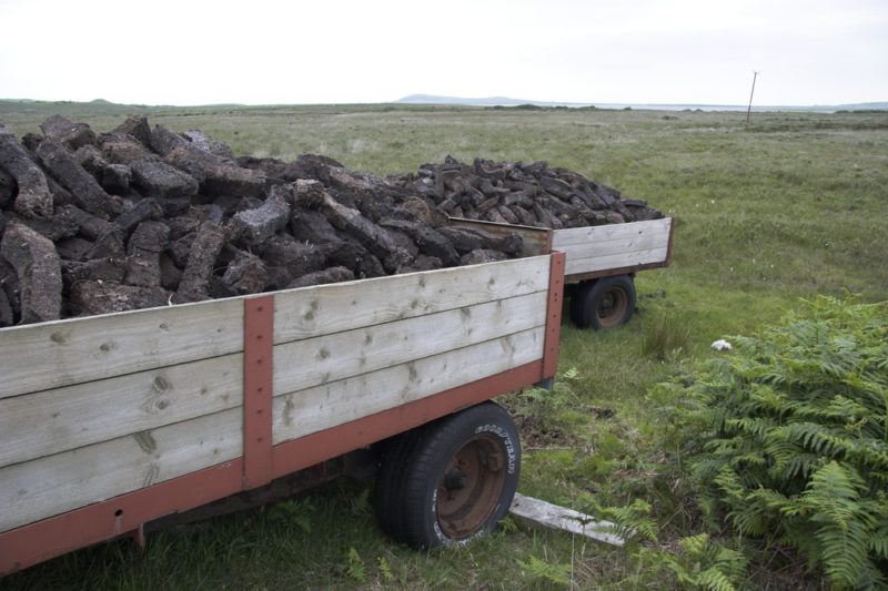 peat mining with pead on wooden cart in scotland