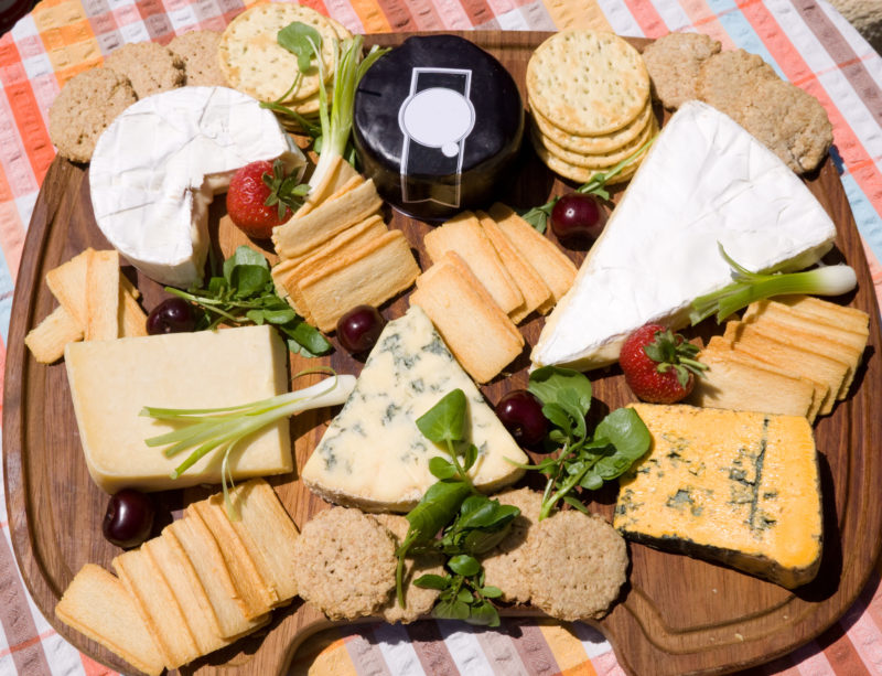 Assortment of different types of cheese on a board. 