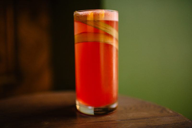 rhubarb infused cocktail in highball glass