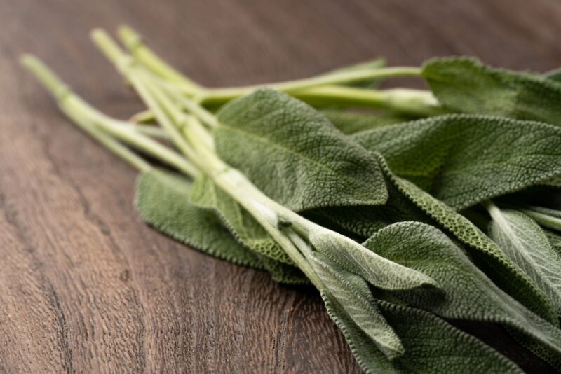 closeup image of a wooden surface with a bunch of sage