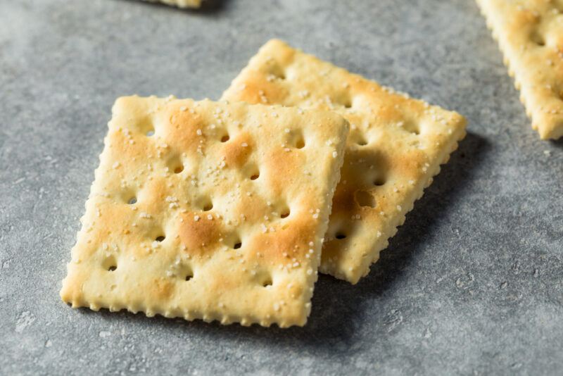 closeup image of a couple of saltines on a grey concrete surface