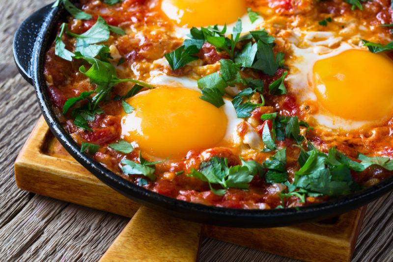 Huevos Rancheros in a pan with eggs and salsa