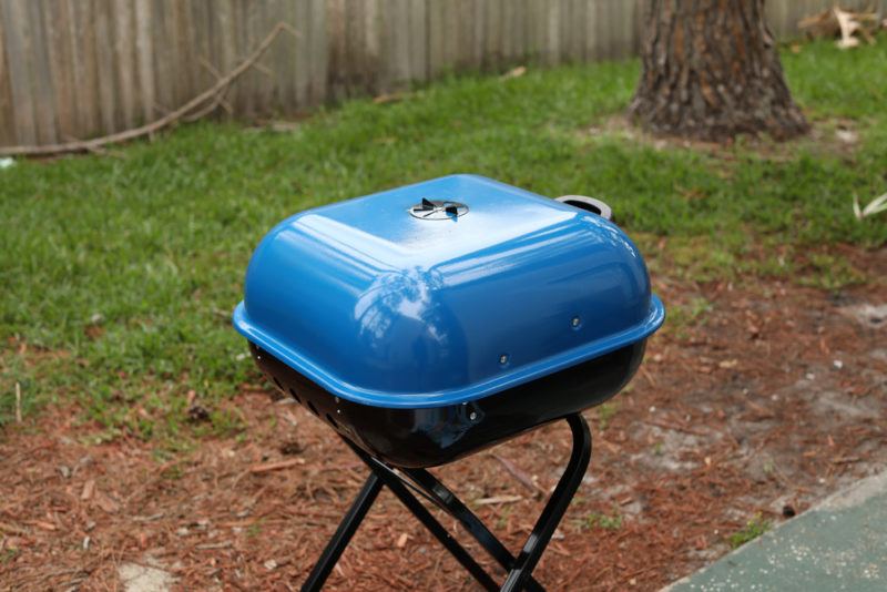 small blue backyard charcoal grill