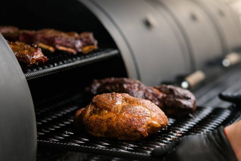 smoked brisket in barrel smoker with seasonings