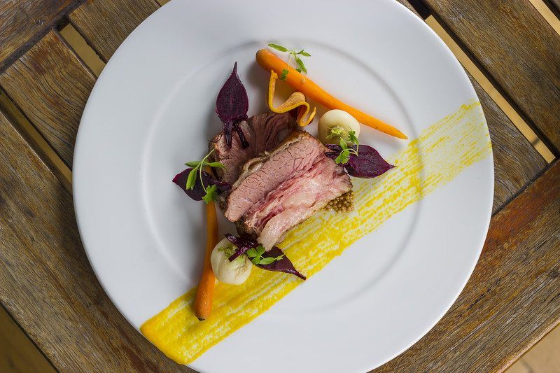 roast beef on plate with garnish in American fusion style