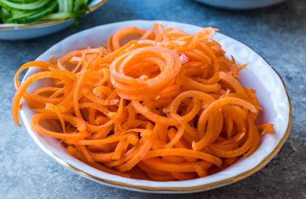 a closeup image of a bowl full of spiralized carrots