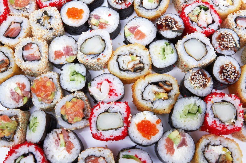 This photo shows an overhead view of several types of sushi.