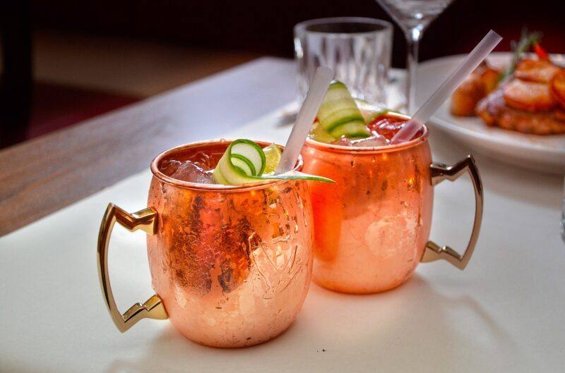 two cocktails in copper glasses with cucumber garnish to represent the best cucumber vodka 