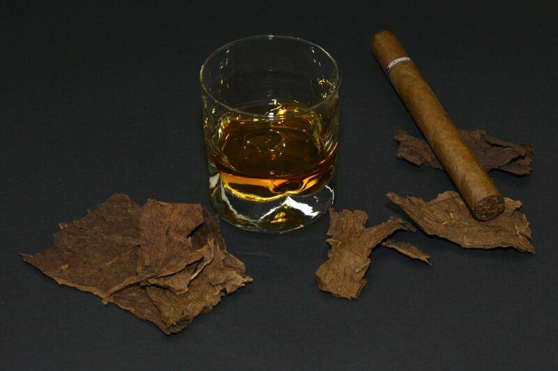 a shot of whiskey next to a cigar to represent the best whiskey shots