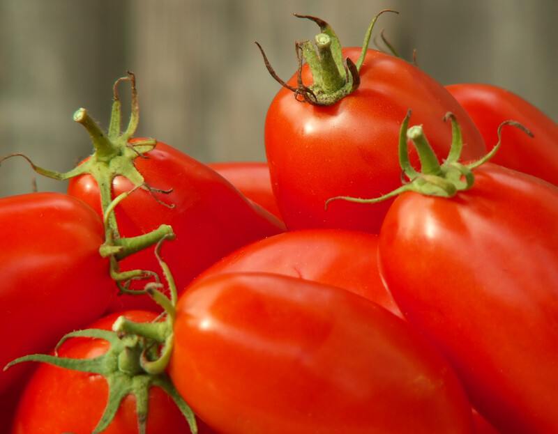 This photo shows several red Roma tomatoes.