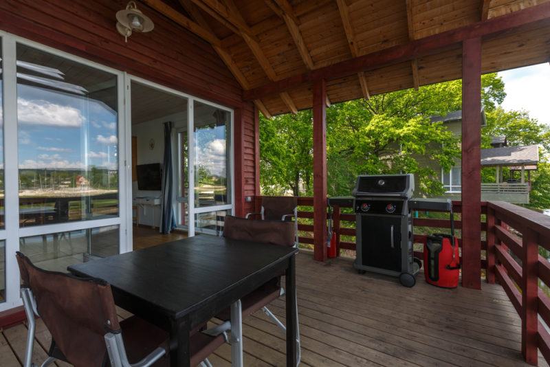 two burner gas grill on outdoor wooden terrace balcony