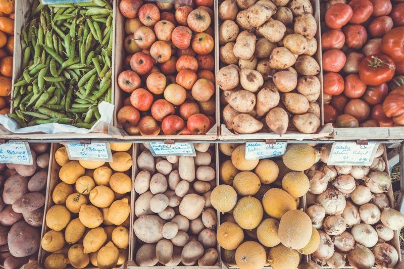 boxes of various fruits and vegetables to represent vegetable delivery services