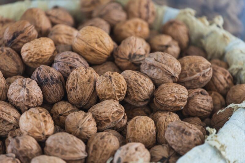 a closeup image of a sack full of walnuts