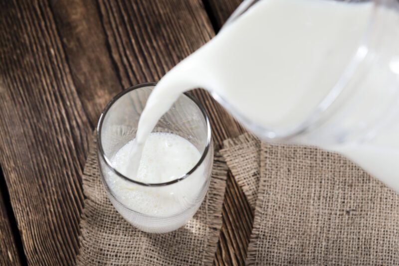 Portion,Of,Milk,On,A,Dark,Wooden,Background,(close-up,Shot) | Food For Net Milk pouring in glass from jug